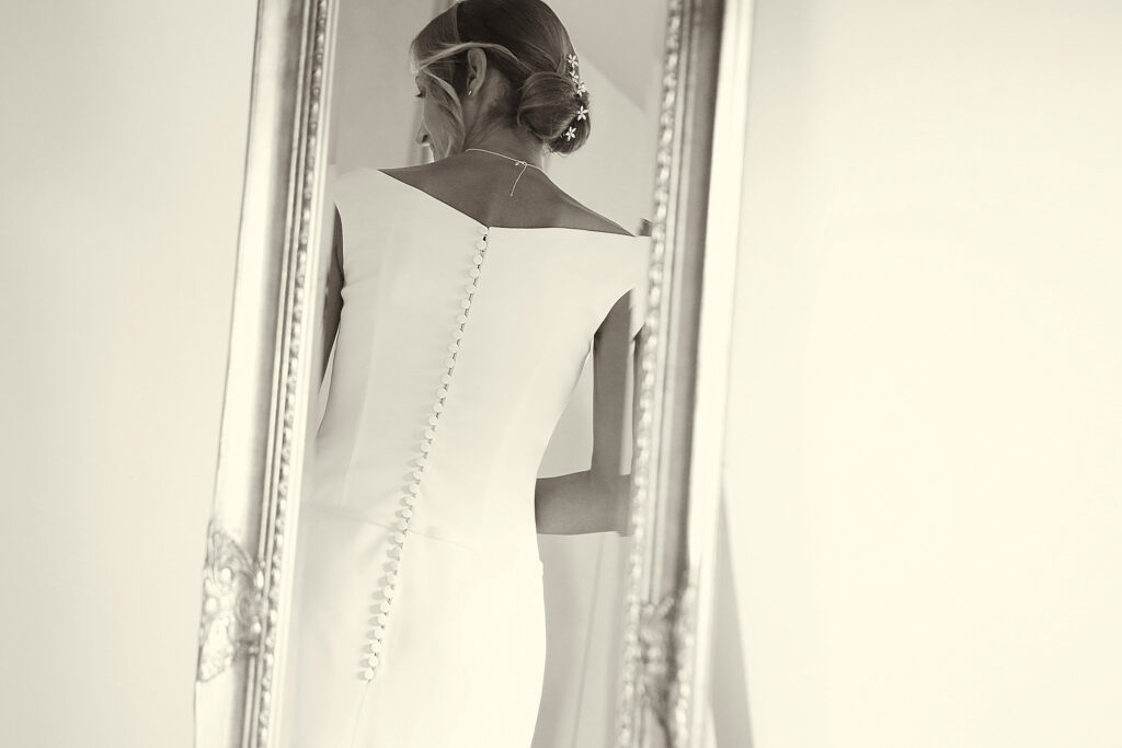 Bride reflected in a mirror wearing her wedding dress