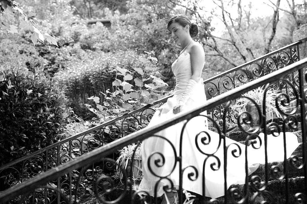 Bride walking down a garden staircase on her wedding day