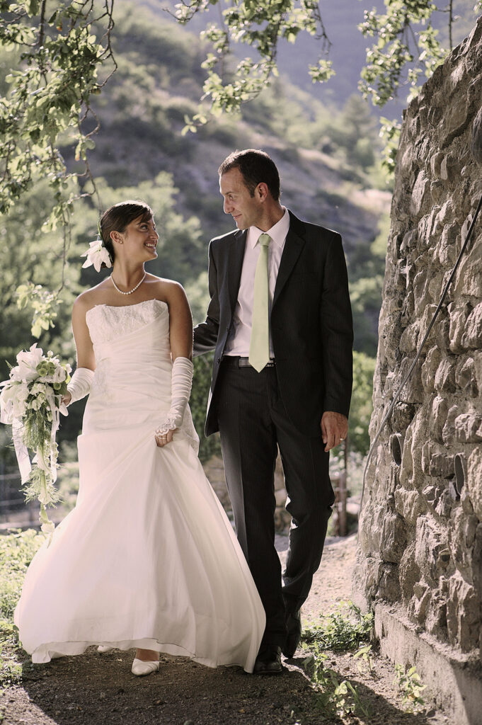 Bride and groom walking together through a garden on their wedding day