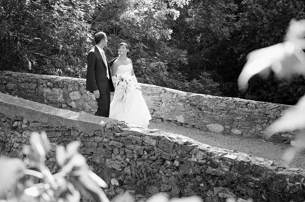 Bride and groom walking together through the garden on their wedding day