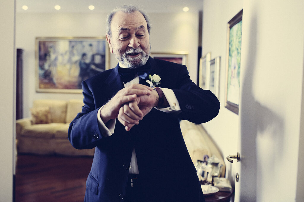 Groom's father checking how much time is left until the ceremony