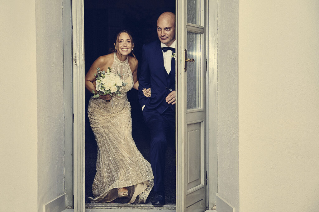 Bride and groom stepping outside together after the wedding ceremony