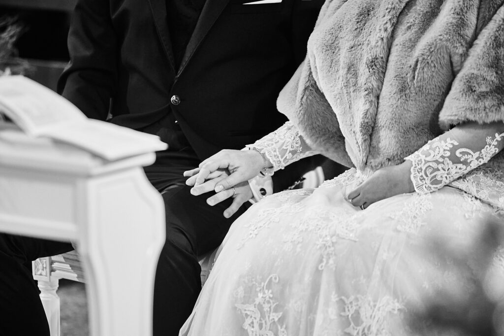 Bride and groom holding hands during their wedding ceremony